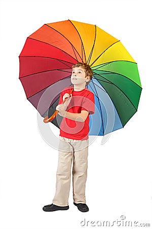 Boy with big multicolored umbrella on white Stock Photo
