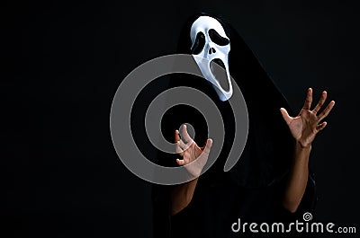The boy in black cover with white ghost mask cosplay to devil ac Stock Photo
