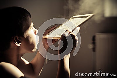 Boy blowing dust from chalk board Stock Photo