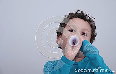 Boy blowing through white paper stock photo Stock Photo