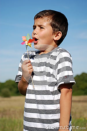 Boy blowing windmill Stock Photo