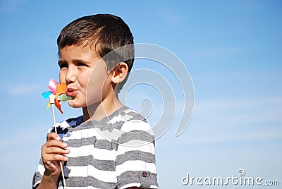Boy blowing windmill Stock Photo