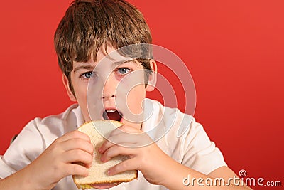 Boy with bologna sandwich vert Stock Photo