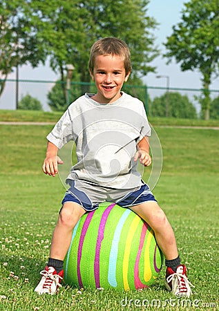 Boy Bouncing on a Ball Stock Photo