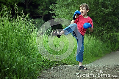 Boy-boxer trains in park Stock Photo