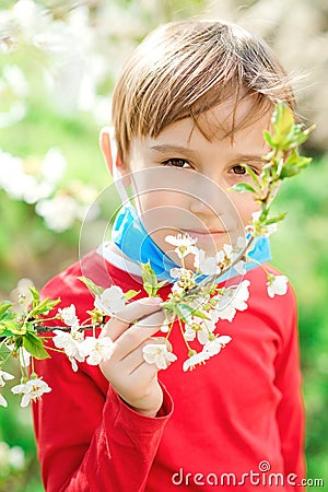 Boy breathe fresh air in a park. Quarantine is over. Breathe deep. Coronavirus ended. Health care concept Stock Photo