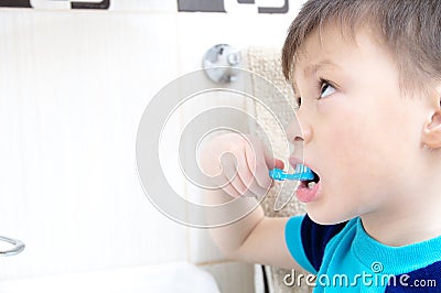 Boy brushing teeth, child dental care, oral hygiene concept, child in bathroom with tooth brush Stock Photo
