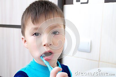 Boy brushing teeth, child dental care, oral hygiene concept, child in bathroom with tooth brush Stock Photo