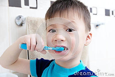 Boy brushing teeth, child dental care, oral hygiene concept, child portrait in bathroom with tooth brush Stock Photo