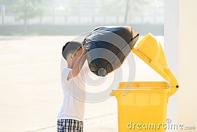 Boy carry garbage Stock Photo