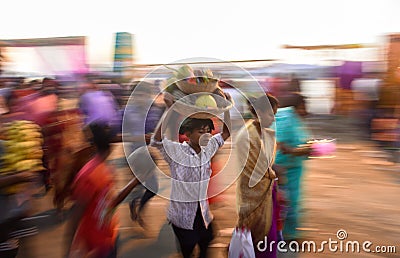A boy carrying basket full of fruits during Chhath Puja in India . Festival . Editorial Stock Photo