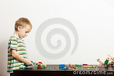 Boy child kid preschooler playing with building blocks toys interior Stock Photo