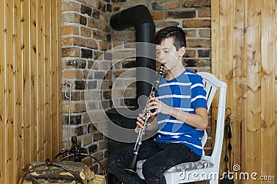 Boy with a clarinet plays music. Online music lesson concept Stock Photo