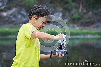 Boy cleans camera with foam Stock Photo