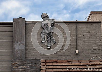 `Boy Climbing`, a public art piece in Deep Ellum in East Dallas, Texas, by Joe Iurato. Editorial Stock Photo