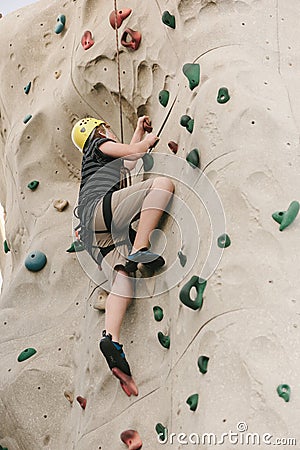 A boy climbing on a rock wall. Stock Photo