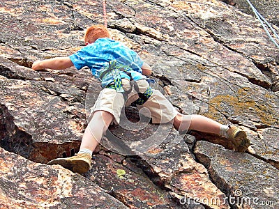 Boy climbing on rope Stock Photo