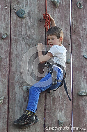 Boy climbing on the wall. Mountaineer Stock Photo