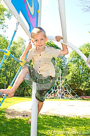The boy climbs the ropes Stock Photo