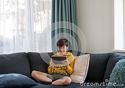 A boy connext to the friend via tablet during qaurantine Stock Photo