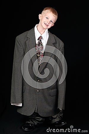 Boy in Dad's Business Suit Stock Photo