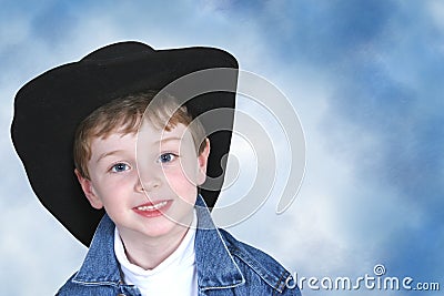 Boy in Denim Jacket and Black Cowboy Hat Stock Photo