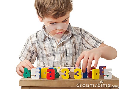 Boy displays wooden figures in form of numerals Stock Photo