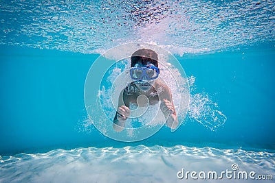 Boy dive in swimming pool Stock Photo