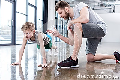 Boy doing push ups with coach Stock Photo