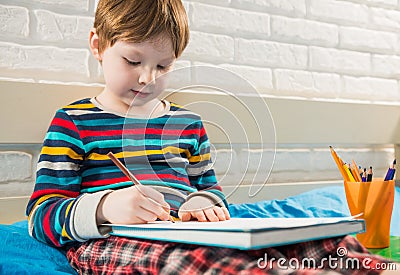 Boy drawing with pencils Stock Photo