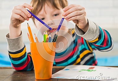 Boy drawing with pencils Stock Photo