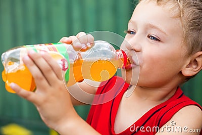 Boy drinking unhealthy bottled soda Stock Photo