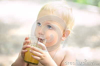 Boy drinks apple juice Stock Photo