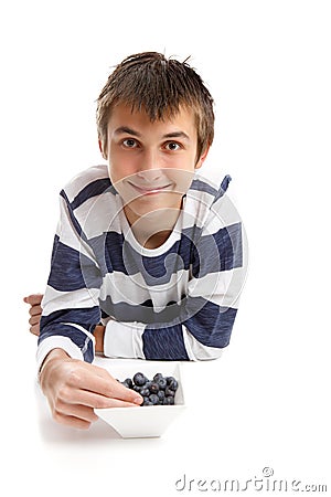 Boy eating blueberries Stock Photo