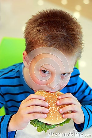 Boy eating burger Stock Photo