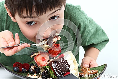 Boy Eating Cheesecake Stock Photo