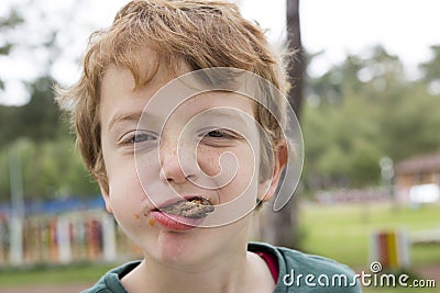 Boy eating meatballs with mouth full Stock Photo