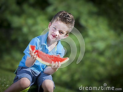 Boy eating melon Stock Photo