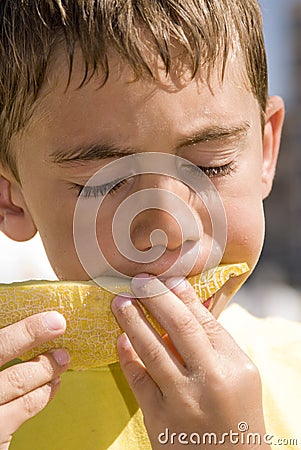 Boy eating melon Stock Photo