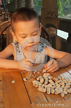 Boy eating peanuts Stock Photo