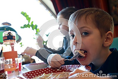 Boy eating vareniki Stock Photo