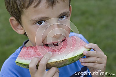 Boy eats watermelon Stock Photo