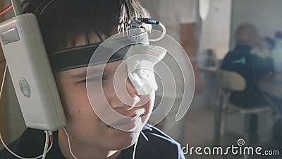 Boy with electrodes on the head looking to monitor - healthcare children`s diagnostic - Ophthalmology researching Stock Photo