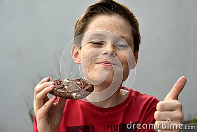 Boy enjoys pastry Stock Photo