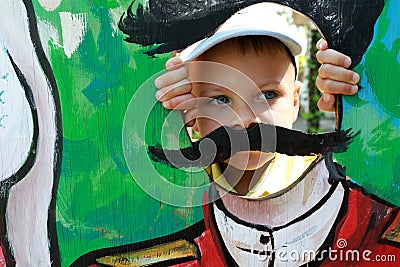 Boy face in Cardboard Cutouts Hole Stock Photo