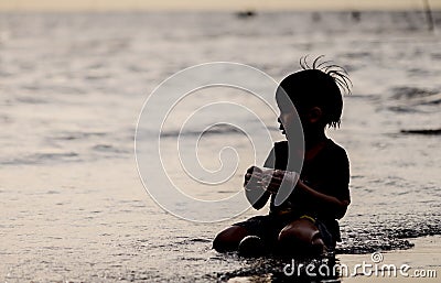 Boy facing out the sea on a Vacation Beach holidays silhouett Stock Photo