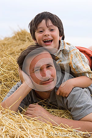 The boy and father on hay Stock Photo