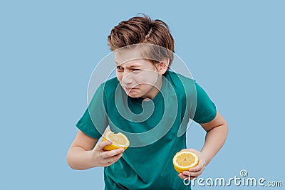 Boy he feels the taste of lemon, sour taste, Stock Photo