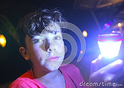 Boy with flashlight on night Stock Photo