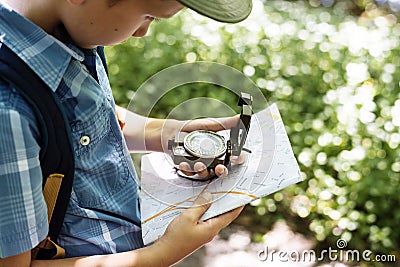 Boy following the directions of a compass Stock Photo